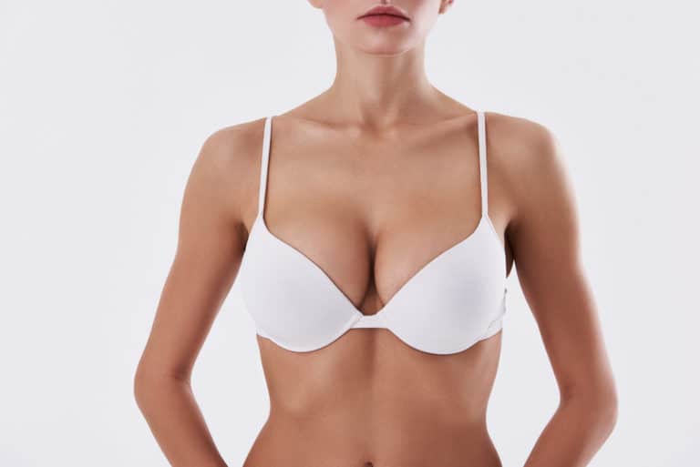 Foto de Woman measure small boobs, small breast do Stock